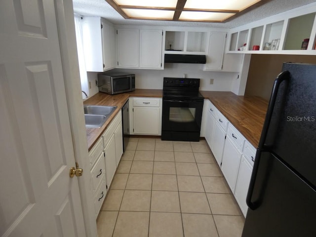 kitchen with white cabinets, wooden counters, light tile patterned flooring, and black appliances