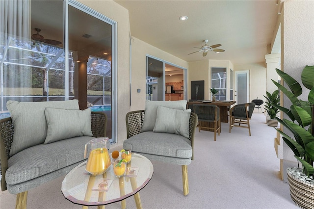 sunroom featuring ceiling fan