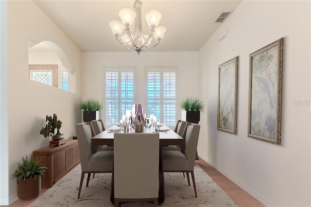 dining area featuring an inviting chandelier, light hardwood / wood-style flooring, and a healthy amount of sunlight