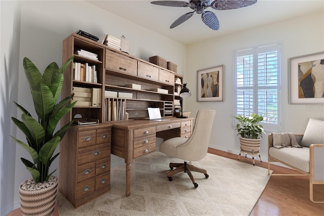 home office featuring light hardwood / wood-style flooring and ceiling fan