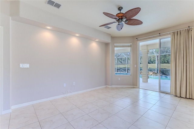 tiled empty room with ceiling fan