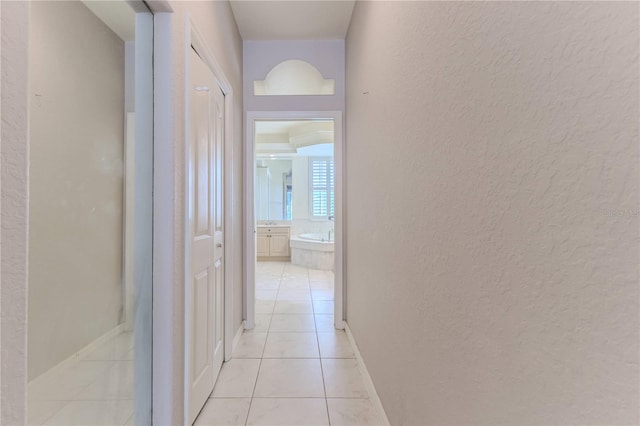 hallway with light tile patterned flooring