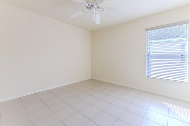 tiled spare room featuring ceiling fan