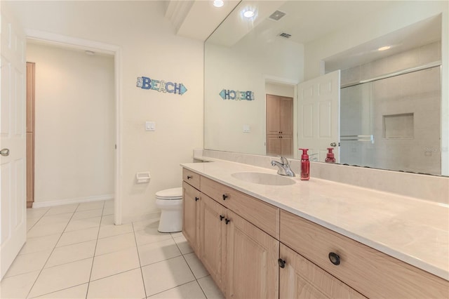 bathroom with toilet, vanity, tile patterned floors, and a shower with door