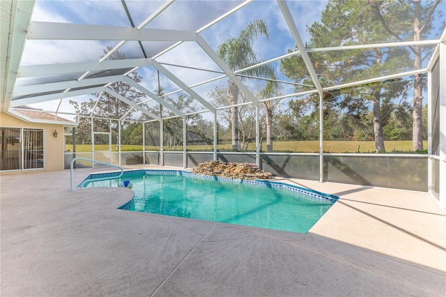 view of swimming pool featuring a lanai and a patio area