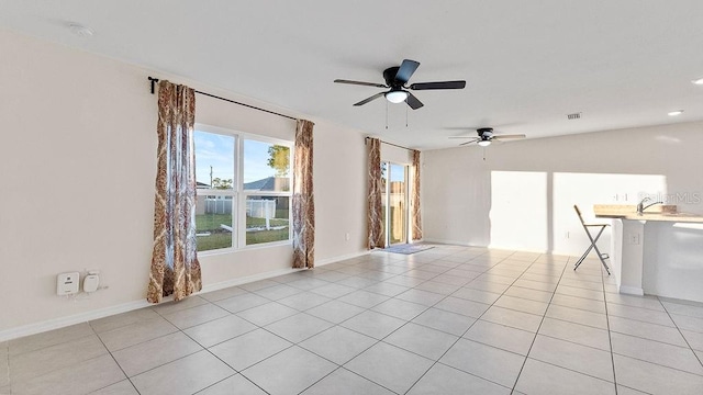 spare room with light tile patterned floors and ceiling fan