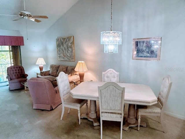 dining space featuring ceiling fan, carpet floors, and high vaulted ceiling