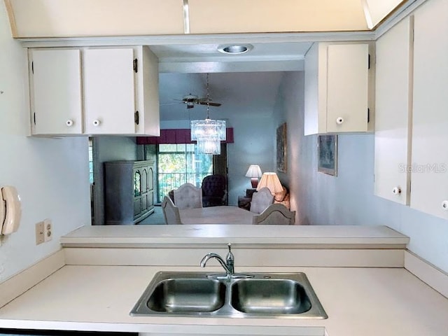 kitchen featuring white cabinetry and sink