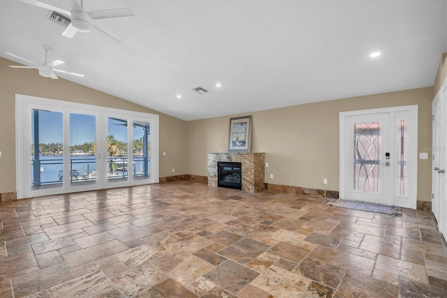 unfurnished living room with ceiling fan, a fireplace, and lofted ceiling