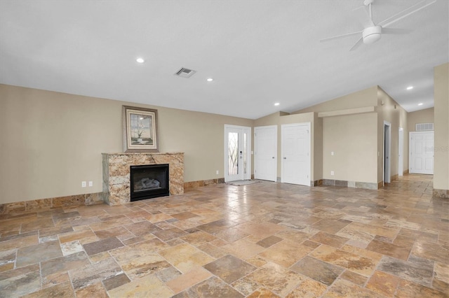 unfurnished living room featuring ceiling fan, lofted ceiling, and a high end fireplace