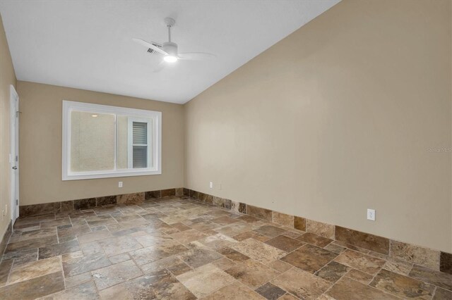 empty room with vaulted ceiling and ceiling fan