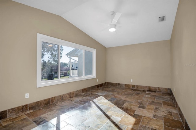 spare room with ceiling fan and lofted ceiling