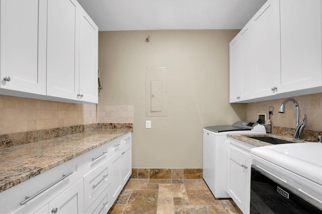 clothes washing area featuring washer / clothes dryer, sink, cabinets, and electric panel