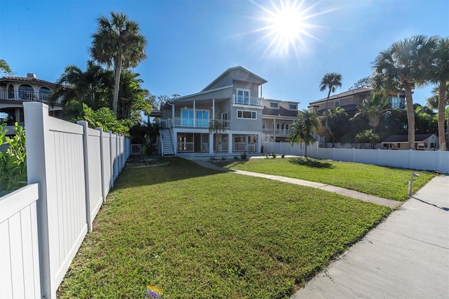 exterior space featuring a yard and a balcony