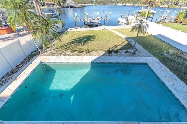 view of pool with a lawn, a boat dock, a water view, and a patio