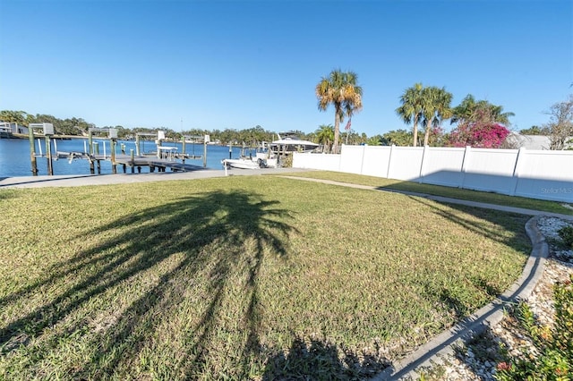 view of yard featuring a boat dock and a water view