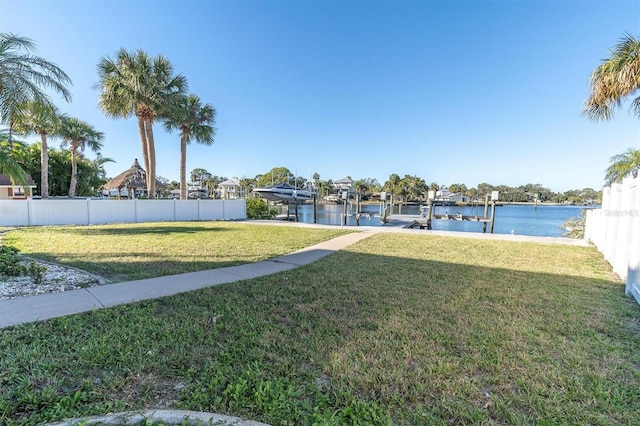 view of yard with a water view and a boat dock