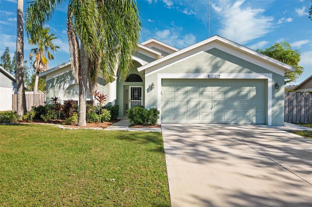 view of front facade with a front yard and a garage