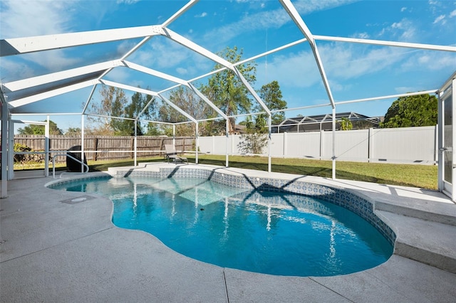 view of pool featuring a patio area, a lanai, and a lawn