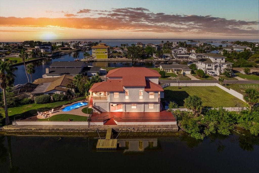 aerial view at dusk with a water view