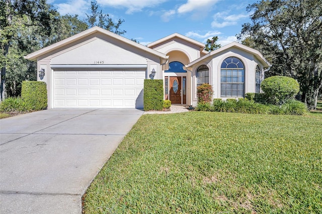 view of front of house with a front yard and a garage