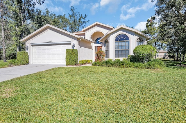 view of front of house featuring a garage and a front lawn