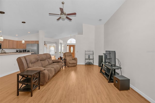 living room featuring lofted ceiling, ceiling fan, and light wood-type flooring