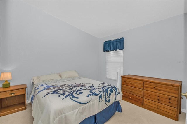 bedroom featuring carpet floors and vaulted ceiling