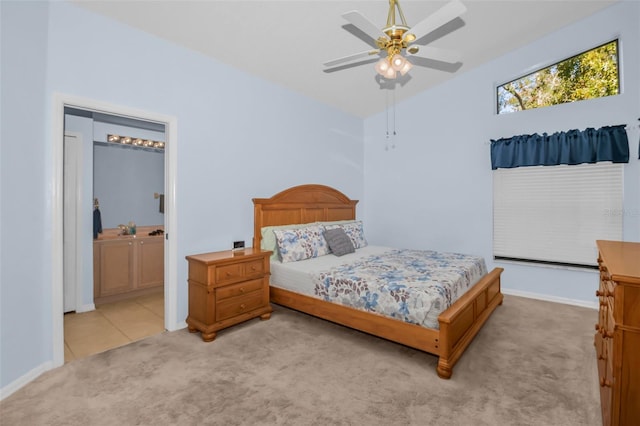 carpeted bedroom featuring ceiling fan and ensuite bathroom