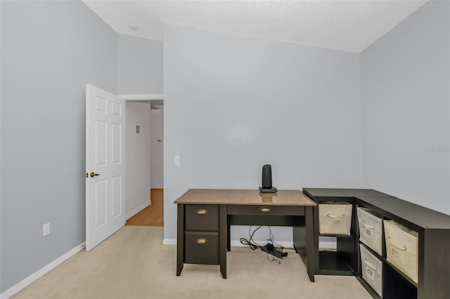 home office with light carpet and lofted ceiling