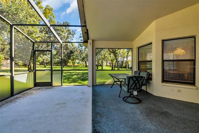 sunroom / solarium with plenty of natural light and vaulted ceiling