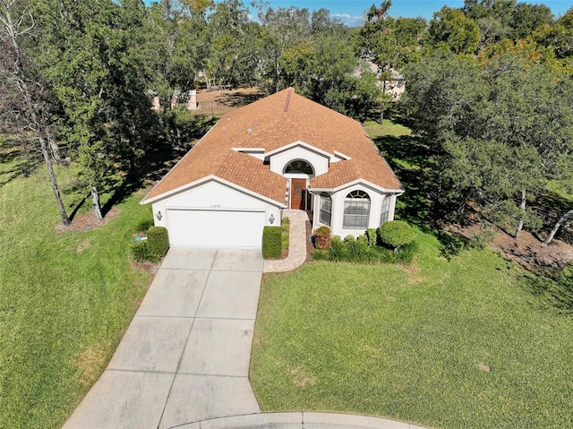 view of front of property with a front lawn and a garage