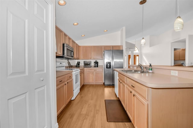 kitchen featuring pendant lighting, lofted ceiling, sink, light brown cabinetry, and stainless steel appliances