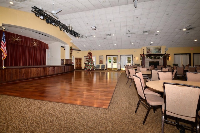 dining room with hardwood / wood-style flooring and high vaulted ceiling