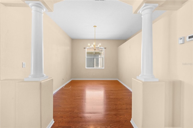 unfurnished dining area featuring a notable chandelier and hardwood / wood-style flooring