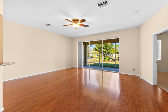 spare room featuring a textured ceiling, hardwood / wood-style flooring, and ceiling fan