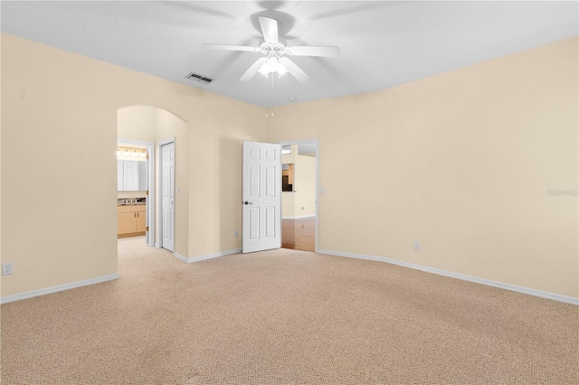 spare room with light carpet and ceiling fan