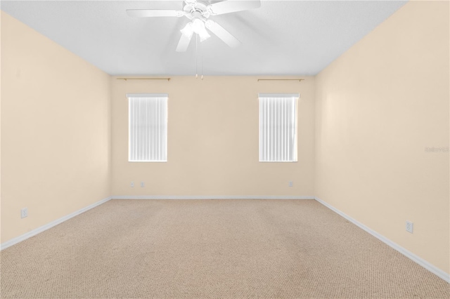 spare room featuring ceiling fan and carpet floors