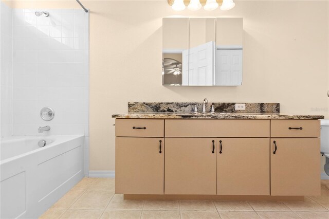 4201 Silver Berry Ct, Spring Hill, FL 34609 - bathroom with vanity, shower / tub combination, toilet, tile patterned flooring, and baseboards