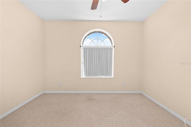 empty room featuring carpet floors and ceiling fan