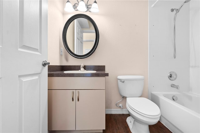 full bathroom featuring vanity, hardwood / wood-style flooring, toilet, and tiled shower / bath combo