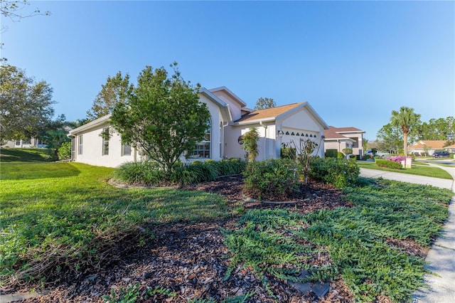 view of front facade with a front lawn and a garage