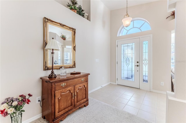 tiled entryway featuring a high ceiling