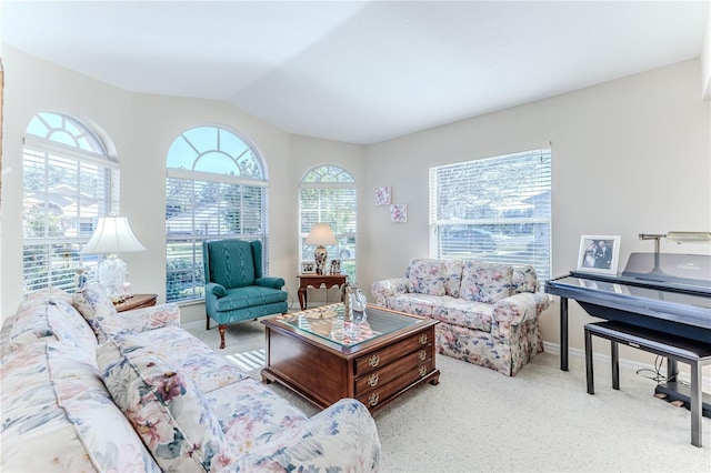 carpeted living room with lofted ceiling and a healthy amount of sunlight