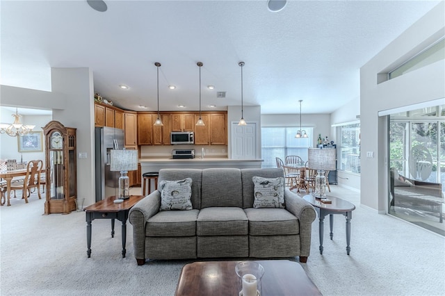 living room featuring a chandelier and light colored carpet