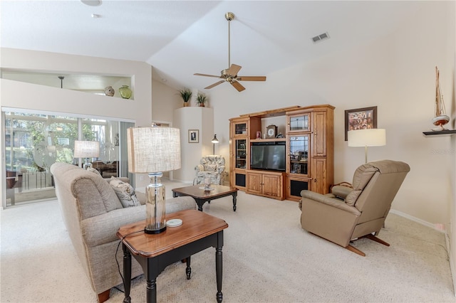 living room featuring ceiling fan, high vaulted ceiling, and light carpet