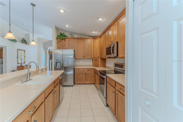 kitchen featuring sink, stainless steel appliances, pendant lighting, lofted ceiling, and light tile patterned floors