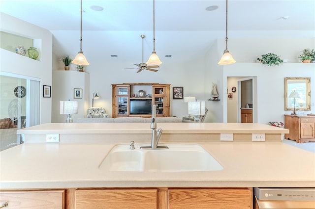 kitchen featuring stainless steel dishwasher, ceiling fan, sink, light brown cabinets, and decorative light fixtures