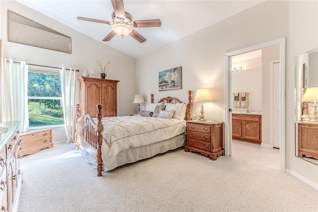 carpeted bedroom featuring ceiling fan, lofted ceiling, and ensuite bathroom