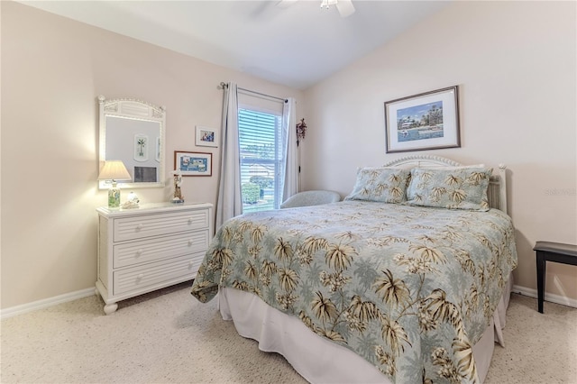 bedroom featuring light colored carpet, vaulted ceiling, and ceiling fan